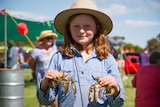 Close up of Zara Guest holding a live yabby in each hand.