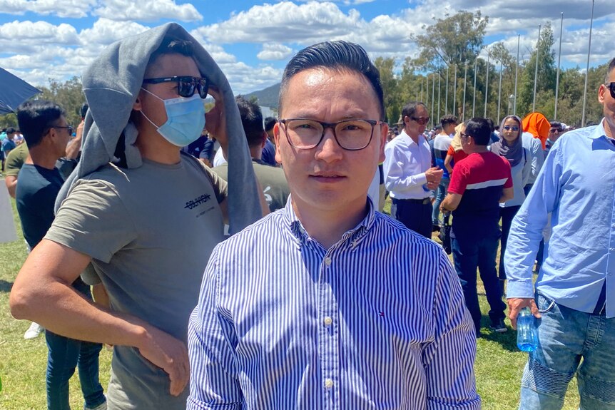 Australian Afghan refugee Zaki Haidari standing and looking at the camera, at a refugee protest in Canberra.