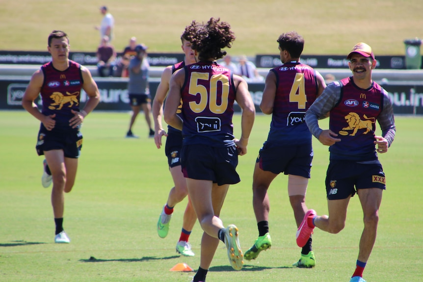 Brisbane Lions players running drills at training