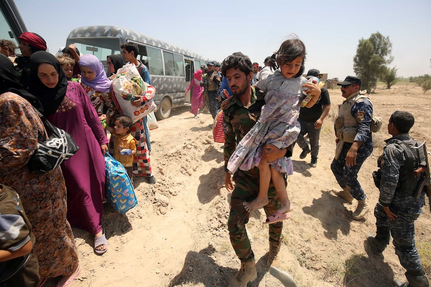 Iraqi forces help families flee Fallujah.