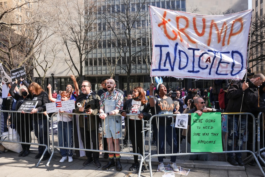 People against former US President Donald Trump gather outside Manhattan Criminal Courthouse.