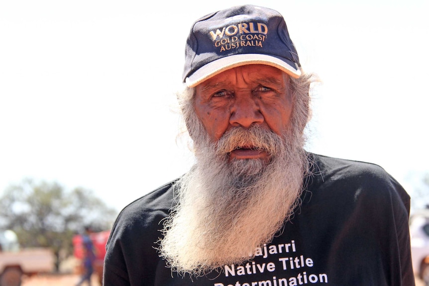 A bearded Aboriginal man looks at the camera