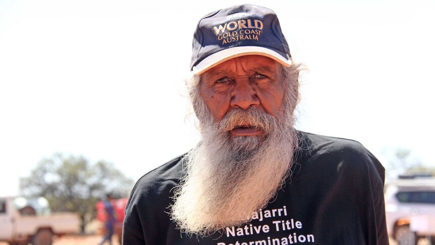 A bearded Aboriginal man looks at the camera
