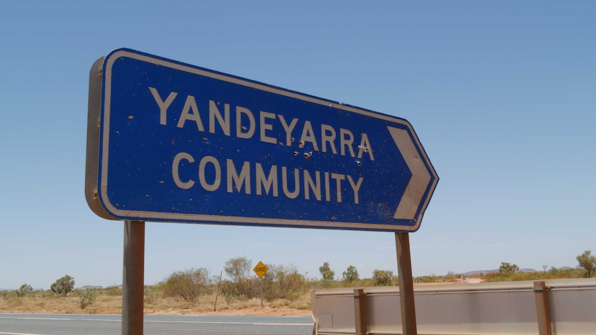 A blue sign points towards Yandeyarra community