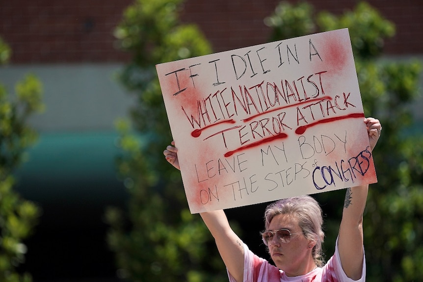 Amanda Luke, of Fairborn, Ohio, holds a sign during a vigil after a mass shooting in Dayton, Ohio, US August 4, 2019.