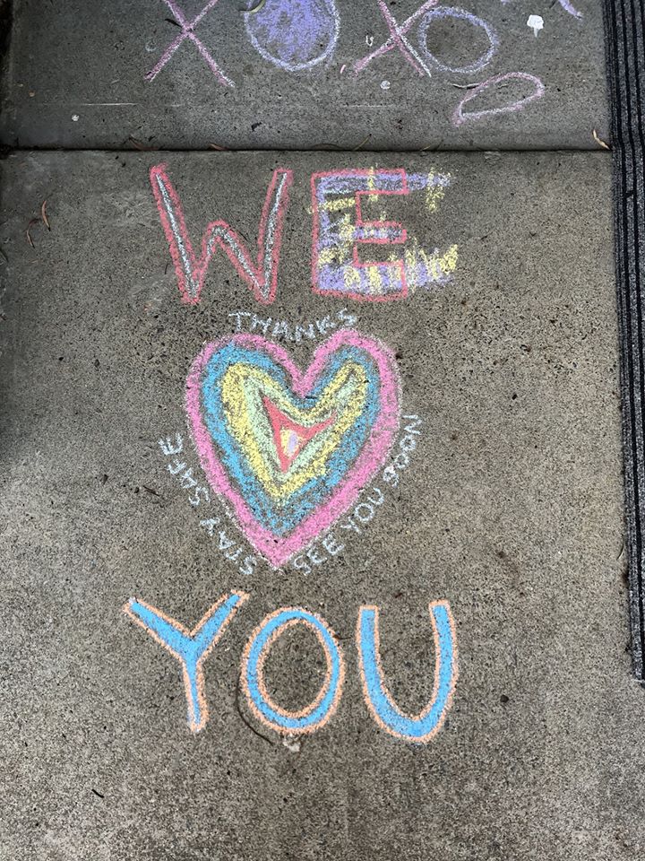 A chalk message saying 'thanks, stay safe, see you soon' around a love heart.