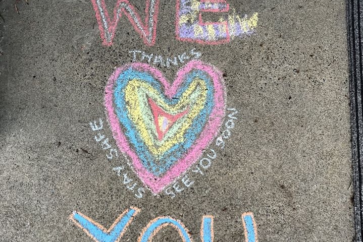 A chalk message saying 'thanks, stay safe, see you soon' around a love heart.