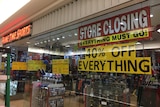 A business has a "Store Closing Everything Must Go!" sign in the shop window.