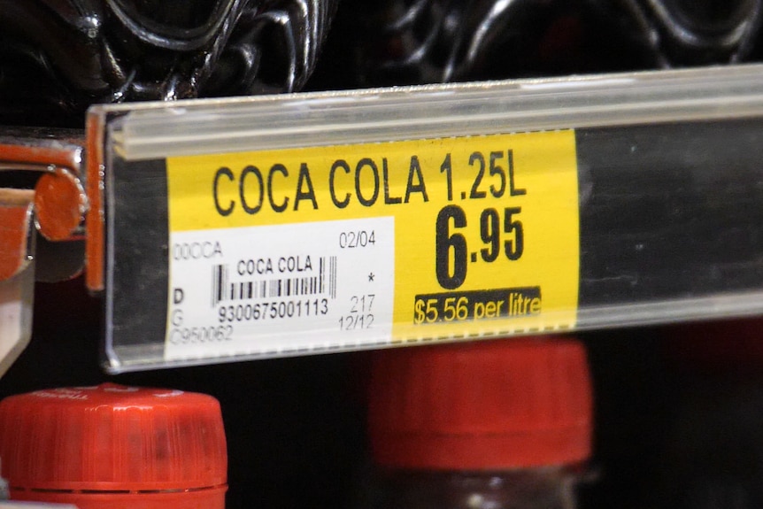 Bottles of Coca-Cola on a supermarket shelf