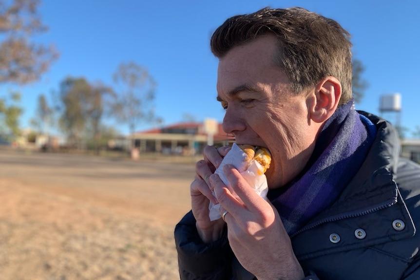 Michael Rowland eating bacon and egg roll.