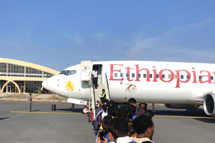 People board an Ethiopian Airlines passenger plane