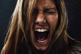 Close up of woman's face in a silent scream.