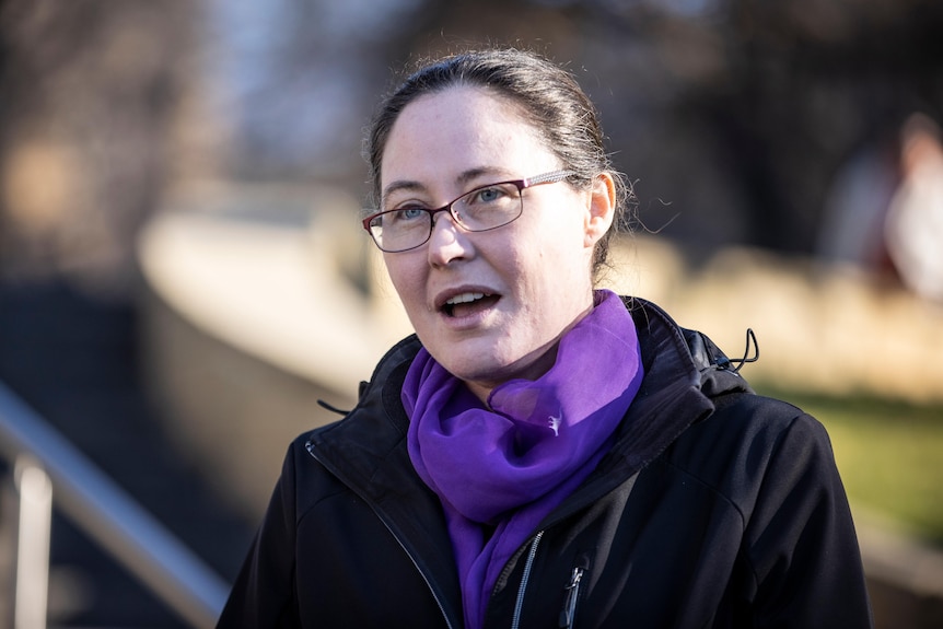 A woman is photographed as she is speaking.