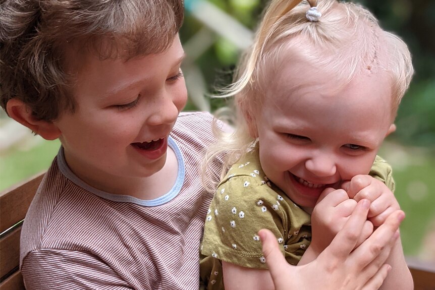 Two children laughing together