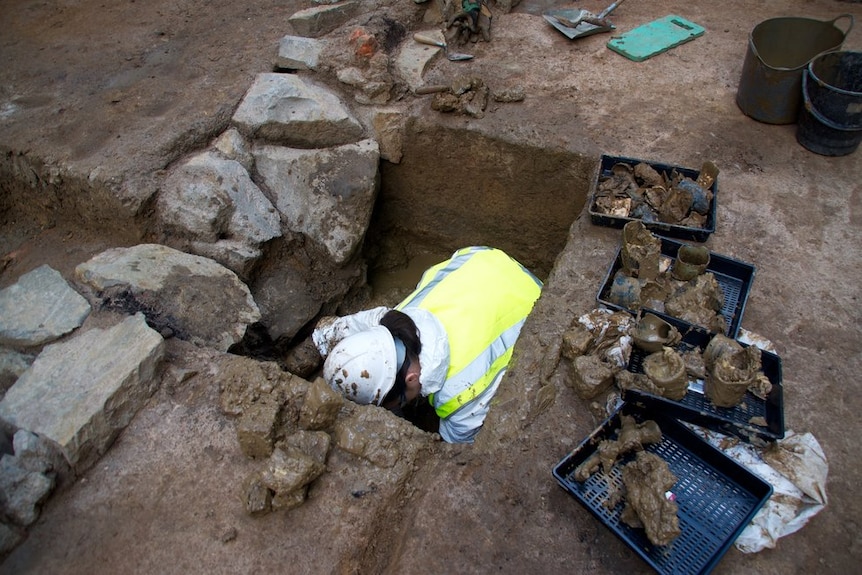 A man digs in a hole.