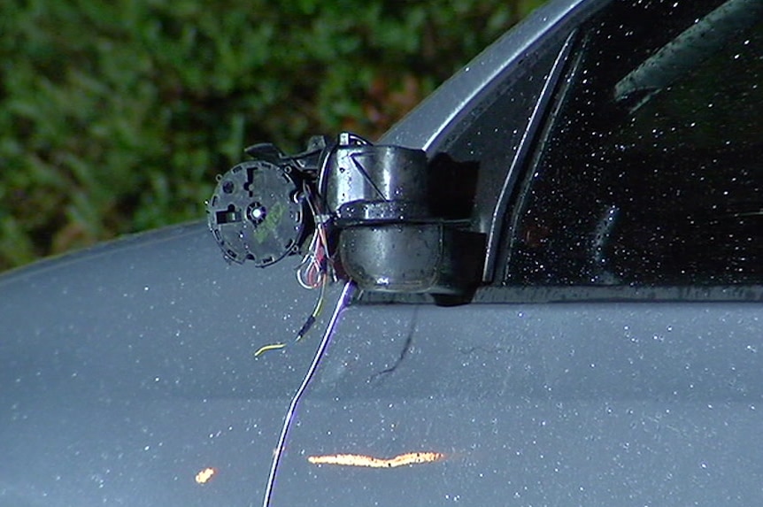 The side mirror has been smashed off the damaged side of the silver Volkswagen Golf.