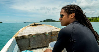 NYT reporter John Eligon rides in a small fishing boat off Thursday Island in the Torres Strait.