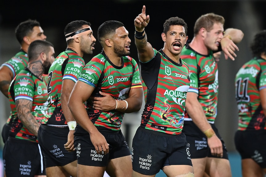 South Sydney's Dane Gagai points to the crowd as he walks with Rabbitohs teammates during an NRL game against Parramatta.