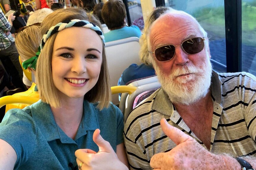 Ashleigh Stevenson smiling and giving a thumbs up alongside fellow train passenger Lawrie McEnally