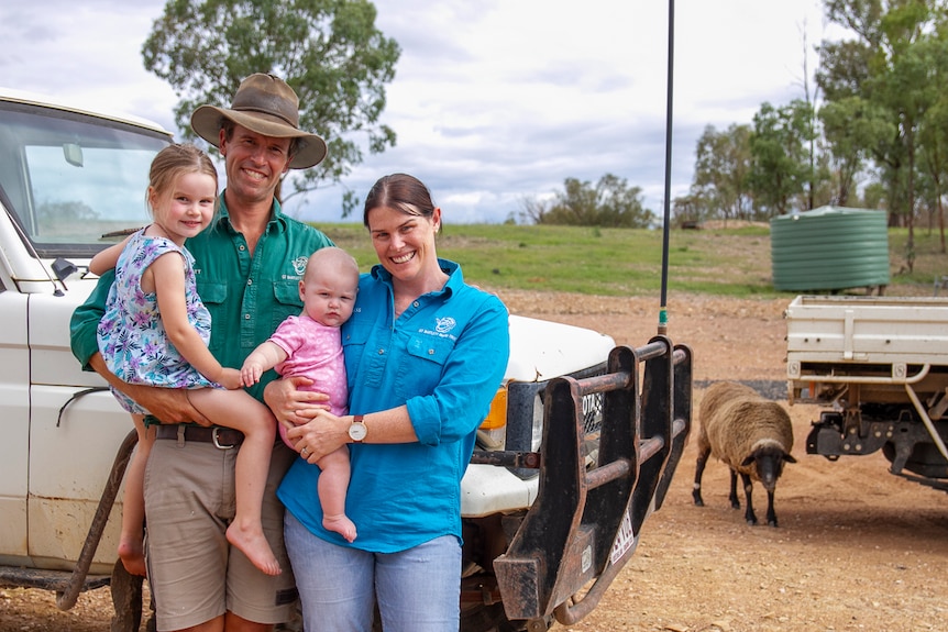 A young farming family, parents and two babies