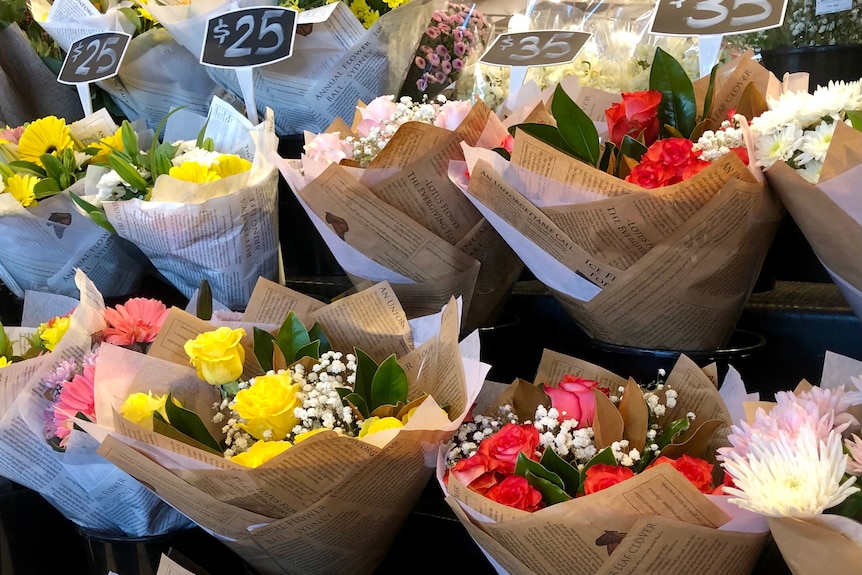 Bouquets of flowers for sale in supermarkets for $25-$35 per bunch.