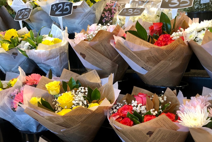 Bouquets of flowers for sale at a supermarket from$25-$35 a bunch.