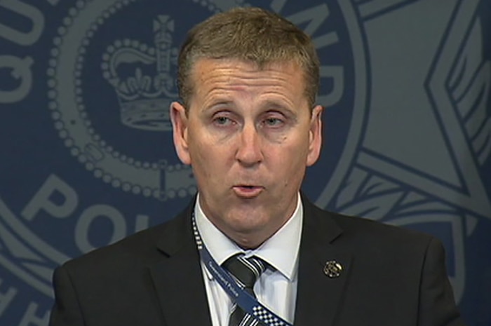 A detective holding a media conference in Brisbane