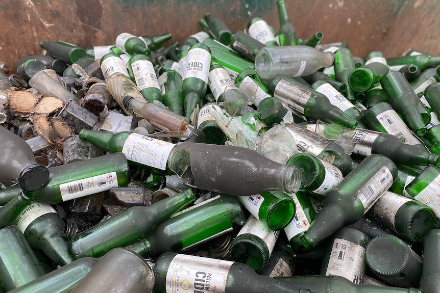 A pile of burnt and smashed bottles after the fire at Batlow.