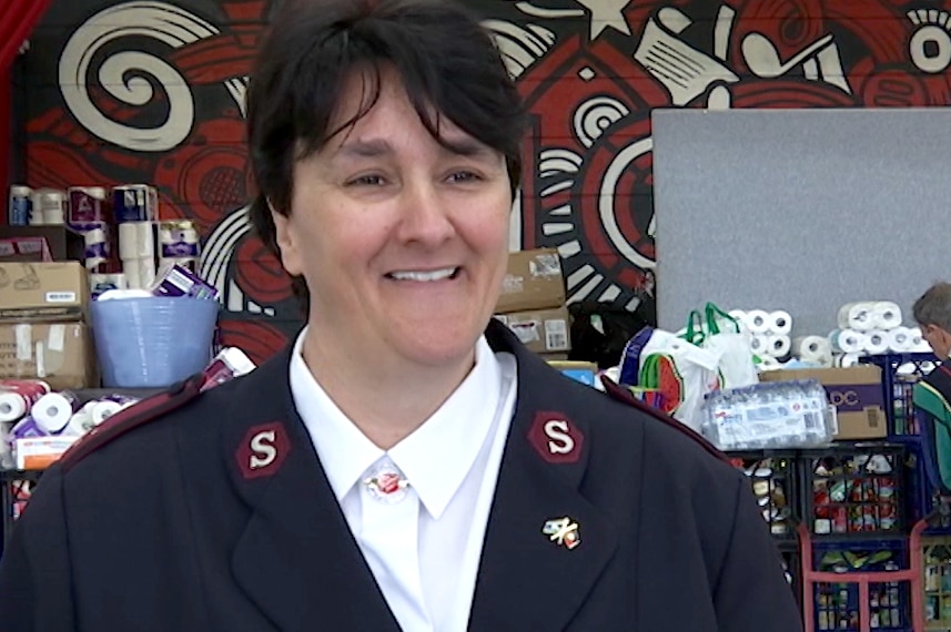 A woman in a Salvation Army uniform smiling in an interview