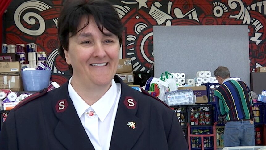 A woman in a Salvation Army uniform smiling in an interview