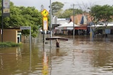 A man carries a mattress through floodwaters in Baroona Road at Rosalie Village in Brisbane, January 12, 2011.