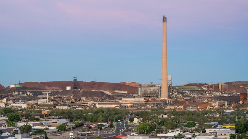 A large stack can be seen in the distance, towering over the town of Mount Isa