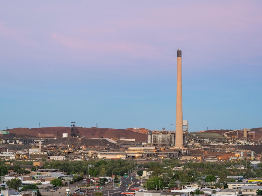 A large stack can be seen in the distance, towering over the town of Mount Isa
