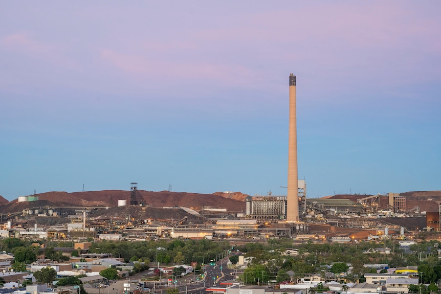 A large stack can be seen in the distance, towering over the town of Mount Isa