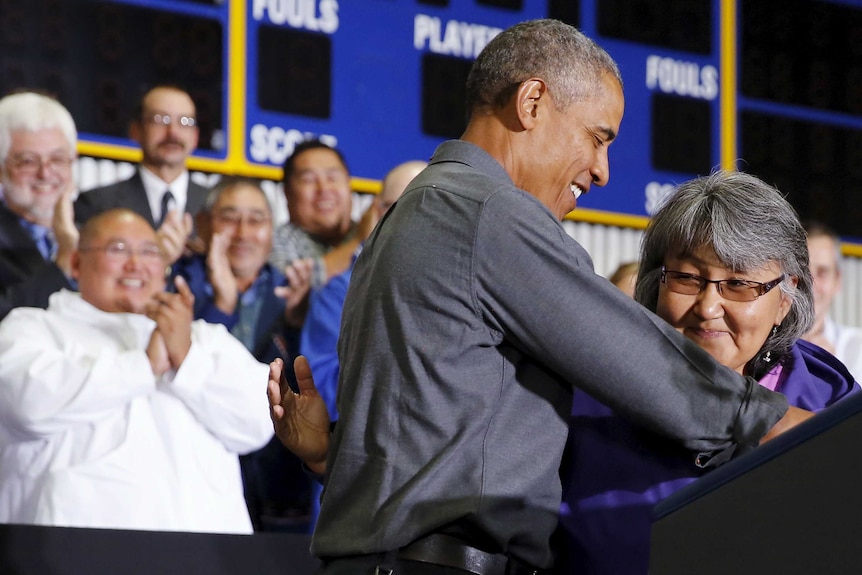 Barack Obama hugs Kivalina council president Millie Hawley