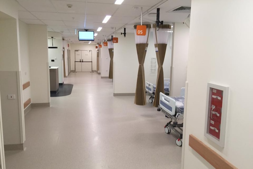 beds visible in alcoves on a hospital ward.