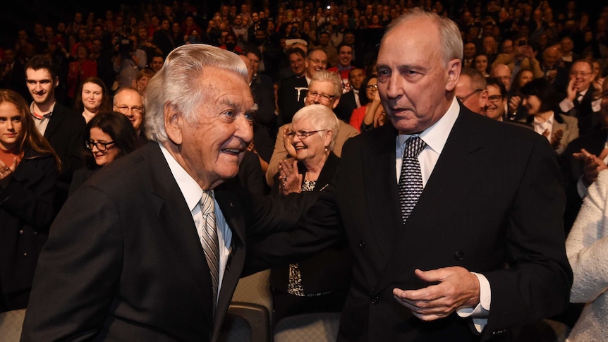 Bob Hawke and Paul Keating stand together, with Mr Keating's hand on Mr Hawke's elbow.