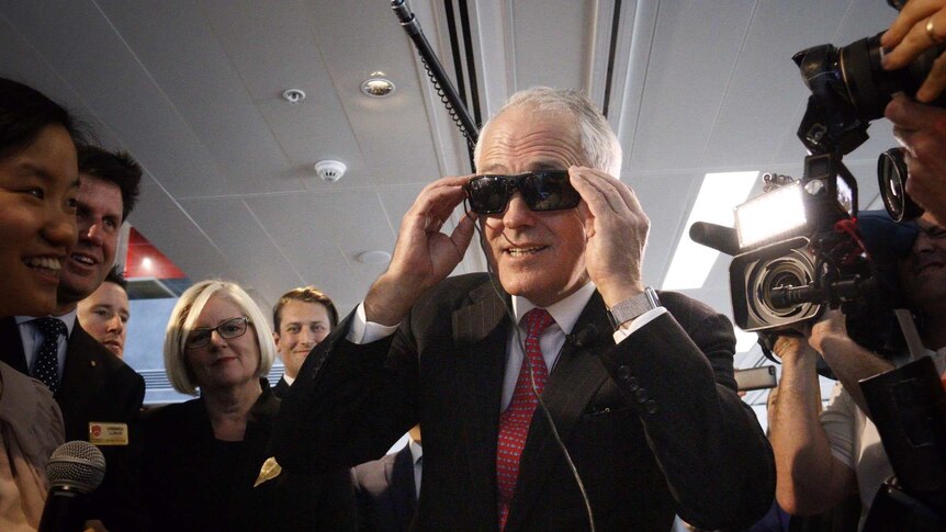 Prime Minister Malcolm Turnbull tries on virtual reality glasses