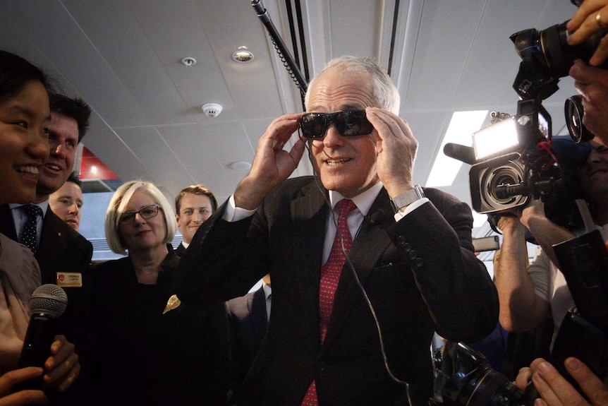 Prime Minister Malcolm Turnbull tries on virtual reality glasses