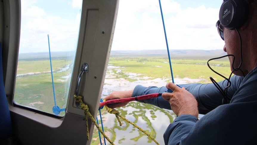 man uses tracking device out of plane