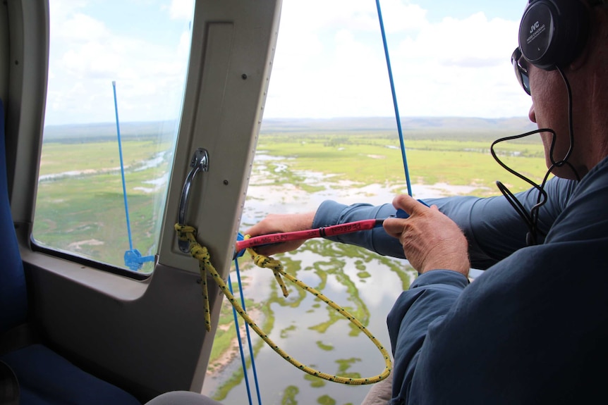 man uses tracking device out of plane