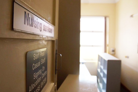 AA door marked Nursing Services opens out to a room inside the old Shenton Park Hospital.