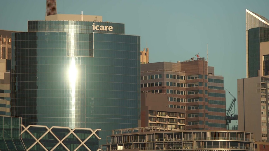 Afternoon sun reflecting of the windows of a building with an icare at the top.