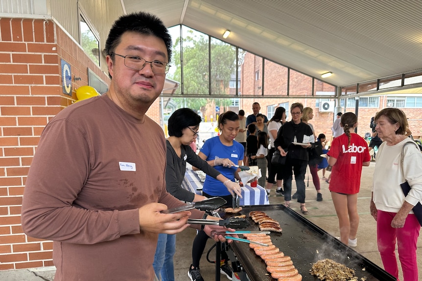 A man behind a BBQ at an election day stall