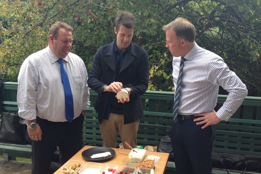 Parliamentary secretary Adam Brooks (L) and Premier Will Hodgman (R) with chef Ben Milbourne.