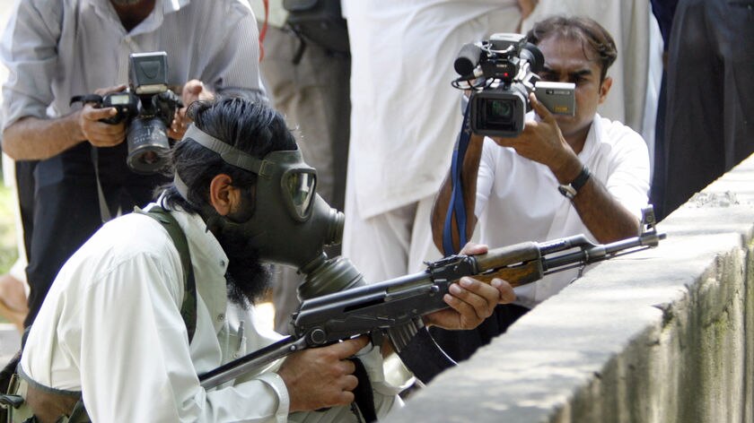 Pakistani religious students of the Red Mosque fire towards paramilitary soldiers