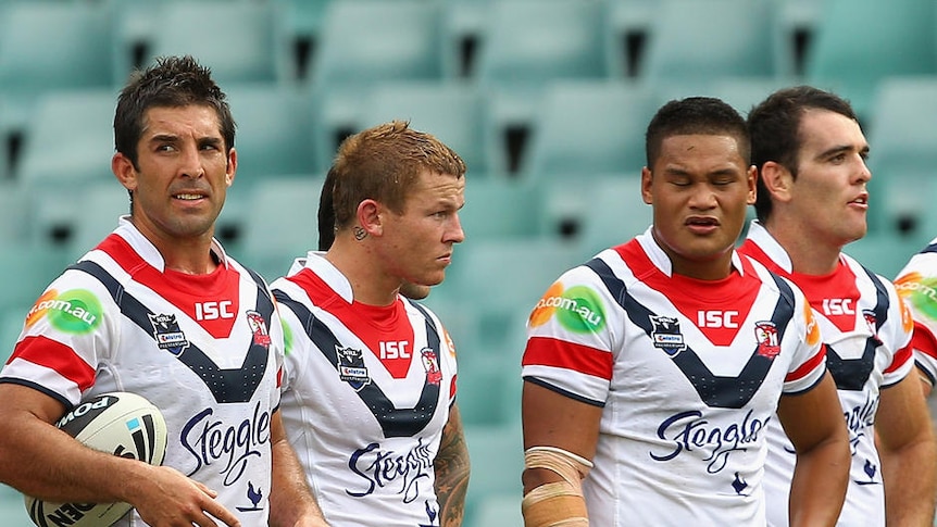 Outmuscled and outsmarted... the Sydney Roosters show their dejection after a Manly try.