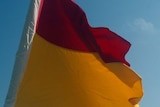 Generic surf lifesaving flag against a blue sky