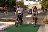 Two riders in the Frome St bike lane