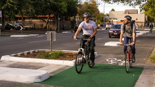 Two riders in the Frome St bike lane